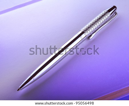 silver pen on notebook