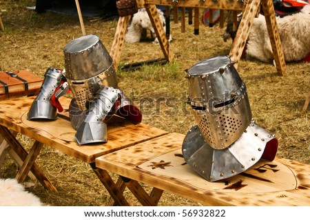 Detail of two medieval helmets arrangetd on a knight camp