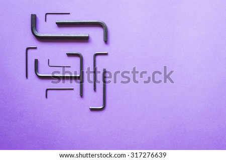Allen keys geometric layout on purple background - squared composition