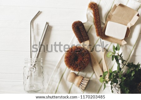 eco natural coconut soap and brushes for washing dishes, metal straws, eco friendly flat lay. sustainable lifestyle concept. zero waste food cleaning. plastic free items. reuse, reduce