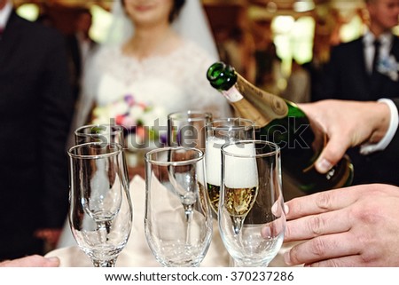 celebrating and toasting happy group of people with champagne at the  wedding reception