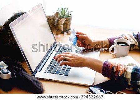 girl holding credit card and typing on laptop, shop online home concept