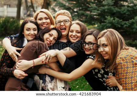 stylish elegant women having fun at celebration in sunny park, funny moment concept, gathering together, photo booth