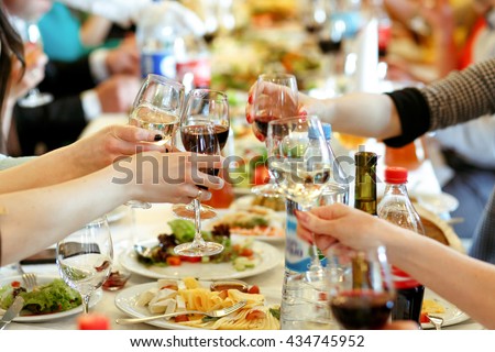 hands holding glasses and toasting, happy festive moment, luxury celebration concept