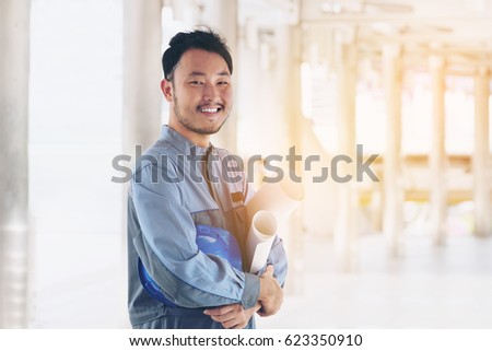 Happy Young Asian Engineer Smiling, Looking at camera. Industrial People Concept. Construction Engineer. Engineer Business. Engineer Portrait. Engineers Equipment. Engineers Uniform. Engineers People.