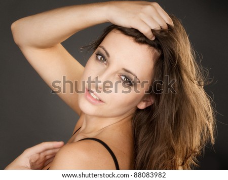Studio head and shoulders shot of beautiful actress with a glowing face against a black background