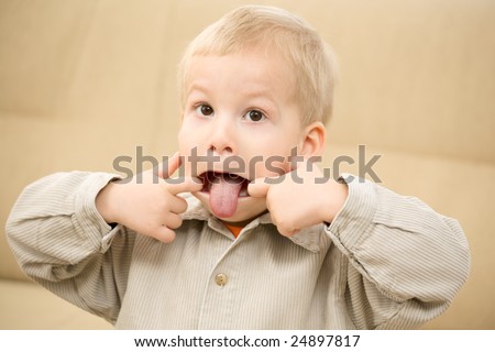 Boy sticking out tongue with a funny face