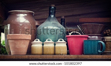 old dirty containers and flowerpots in shelf