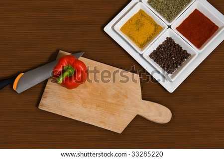 top view from kitchen with collection of spices and plank with knife