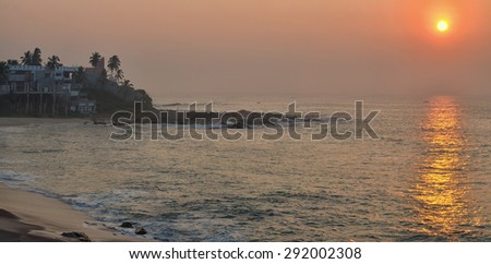 Coastal sun rise with  hotel in the foreground