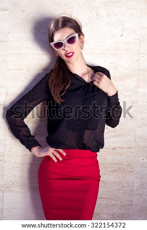 Autumn fashion close up portrait of young brunette sexy woman wearing black blouse,red skirt .Elegant business woman looking happy and seductive.thin slender figure perfect body and pretty make-up