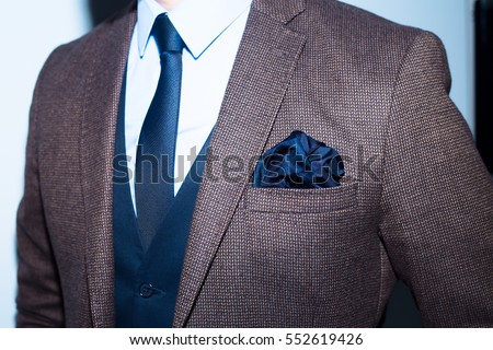 men suit perfect to the last detail.Man posing in brown suit