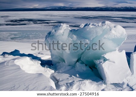 Large block of ice on the surface of a lake