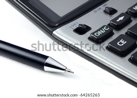Pen and calculator side view on white background