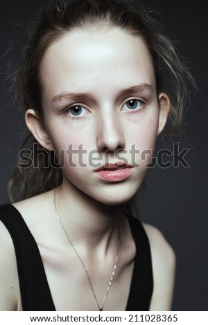 Close-up face portrait of young woman without make-up. Natural image without retouching, shallow depth of field.