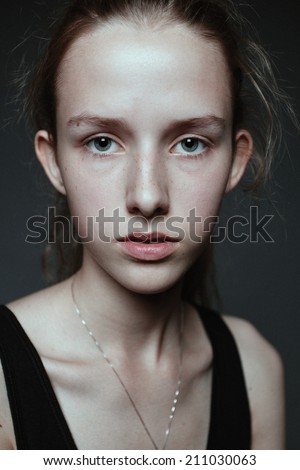Close-up face portrait of young woman without make-up. Natural image without retouching, shallow depth of field.