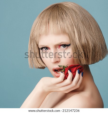 beautiful blonde wig with a red rose in her hand on a blue background