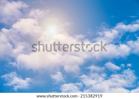 blue sky with clouds and sun shining through the clouds