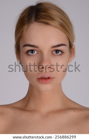 Close-up face portrait of young woman without make-up. Natural image without retouching . Shallow depth of field.