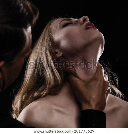 Domestic violence woman being abused and strangled by strong man. on dark background