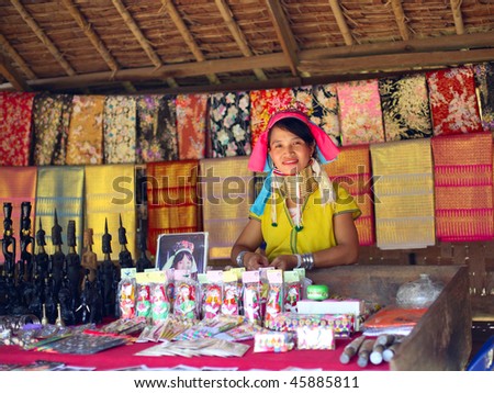 KAREN VILLAGE, THAILAND - AUG 21:A woman from The Padaung-Karen long-necked tribe sells goods at the local market on August 21, 2007 in Karen Village, Thailand