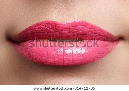Perfect smile. Beautiful full pink lips and white teeth. Pink lipstick. Gloss lips. Make-up & Cosmetics
