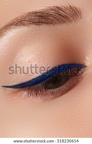 Beauty make-up for blue eyes. Perfect skin, long eyelashes. Classic blue arrows makeup. Retro make up. Eyeliner makeup