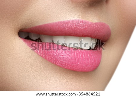 Macro happy woman\'s smile with healthy white teeth, bright pink .lips make-up. Stomatology and beauty care. Woman smiling with great teeth. Cheerful female smile with fresh clear skin
