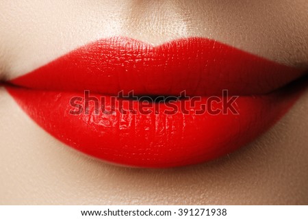 Close-up shot of woman lips with red lipstick. Beautiful perfect lips. Sexy mouth close up. Beautiful wide smile of young fresh woman with full lips