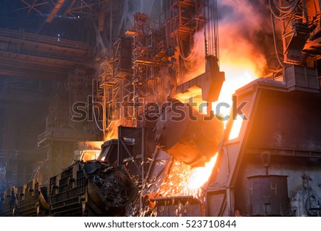 pouring cast iron into the converting furnace to produce steel