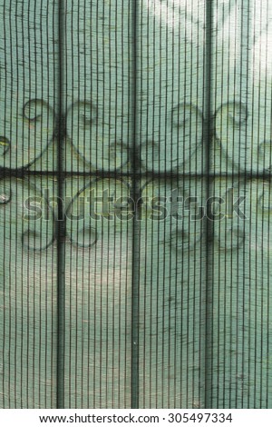 wrought iron door behind shading net,focus shading net.