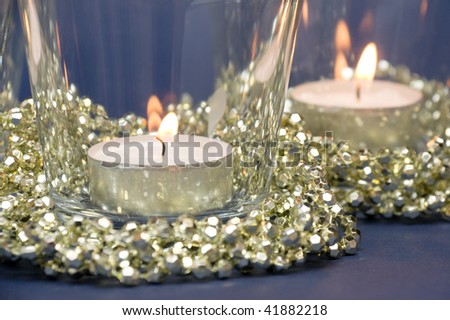 Two candles in glass and golden decoration beads