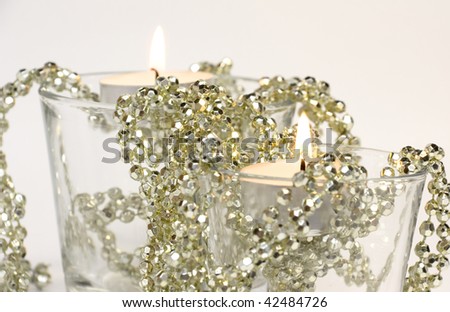 Two candles in glass with golden decoration beads