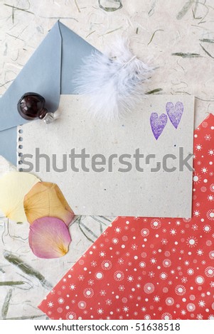 Group of colored paper, petals, bottle and feather