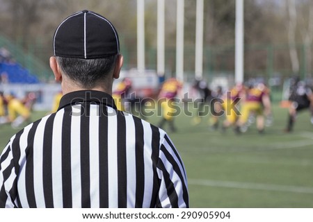 Football referee observing the match