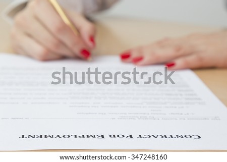 Woman signing employment contract