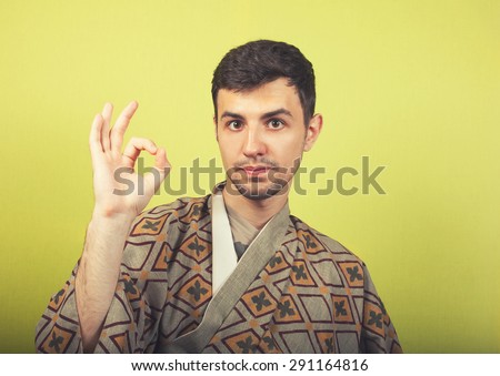 man wearing kimono shows ok