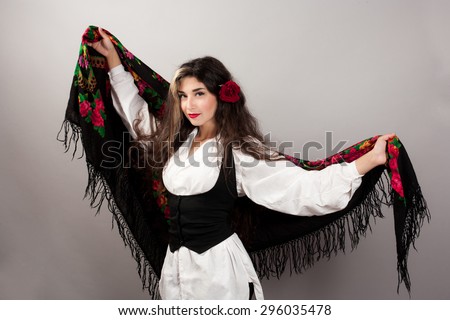 Beautiful woman with scarf and rose in her hair