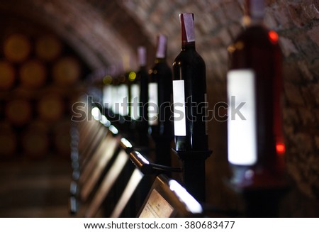 Row of vintage wine bottles in a wine cellar