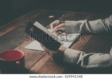 home office desk background, Desk musicians, hand holding pencil and writing note on wood table,Checklist Notice Remember Planning Concept