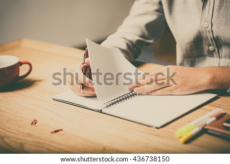 home office desk background, Desk musicians, hand holding pencil and writing note on wood table,Checklist Notice Remember Planning Concept