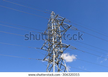 Electricity metal pole silhouette in blue sky
