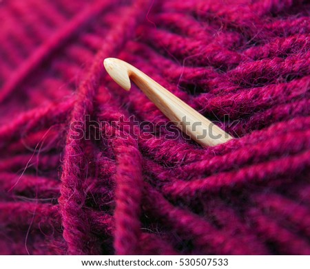 Clew of knitting wool yarn with bamboo crochet, bright pink threads for crochet handicraft