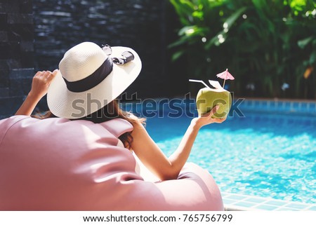 Young asian woman relaxing in swimming pool at spa resort.relaxing and spa relax concept.