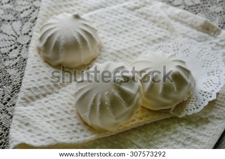 Closeup of white glazed vanilla-flavored zephyr on white napkins