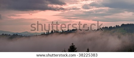 Misty morning of hilly area with ray of light. Carpathian mountain, Ukraine