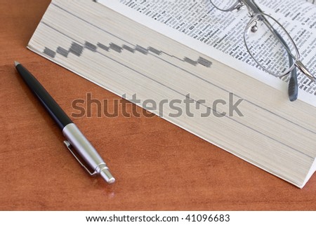 open dictionary with a pair of glasses and pen
