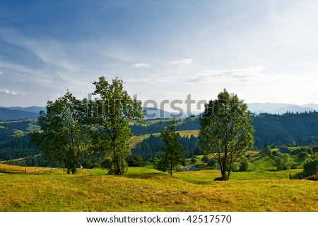 Rural landscape with trees, hills and mountains