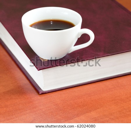 Coffee and book on a wooden table