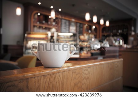 White cup of coffee at the cafe interior